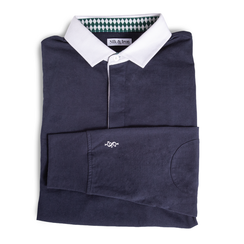 Folded navy blue polo shirt with white collar on a white background