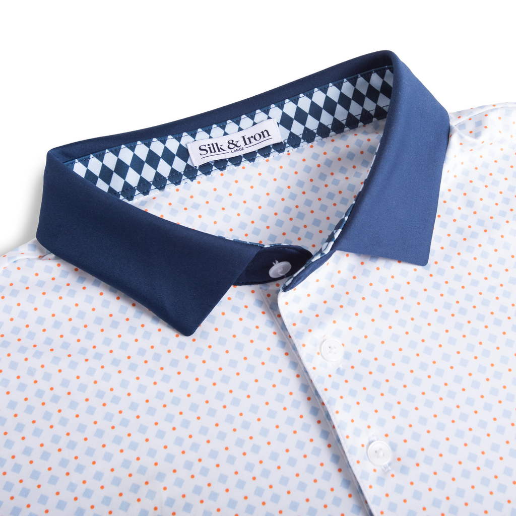 Close-up of a patterned shirt with a blue collar and 'Silk & Iron' label.